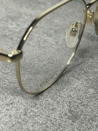 Gucci GG1145O – Złote Oprawki Optyczne z Kremowymi Zausznikami